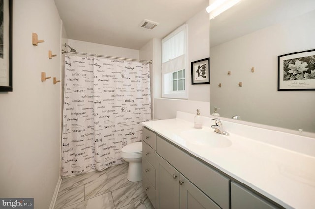 bathroom featuring marble finish floors, toilet, vanity, and a shower with curtain