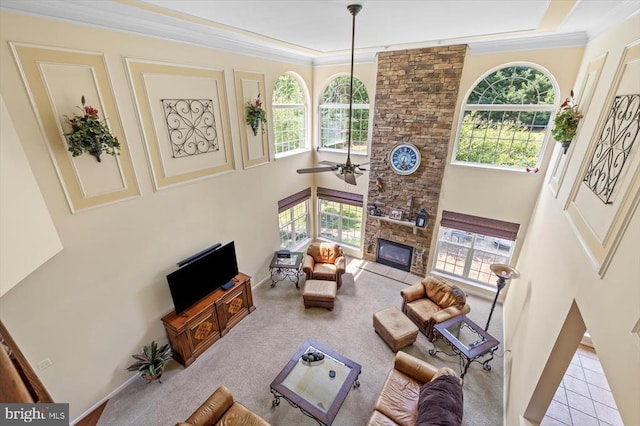 11110 Park Ridge Rd, Fredericksburg, VA 22408 - carpeted living room with crown molding, a ceiling fan, a towering ceiling, and a stone fireplace