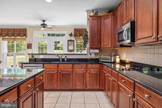11110 Park Ridge Rd, Fredericksburg, VA 22408 - kitchen featuring light tile patterned floors, ceiling fan, a sink, stainless steel microwave, and decorative backsplash