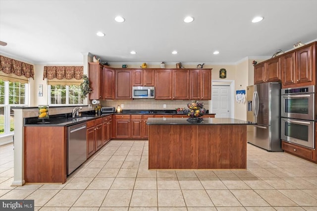 11110 Park Ridge Rd, Fredericksburg, VA 22408 - kitchen with a sink, appliances with stainless steel finishes, a kitchen island, light tile patterned flooring, and ornamental molding