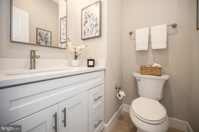 92 Mill Run, Bumpass, VA 23024 - bathroom featuring vanity, toilet, baseboards, and wood finished floors