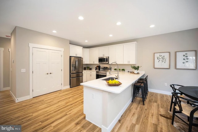 92 Mill Run, Bumpass, VA 23024 - kitchen featuring a sink, a peninsula, stainless steel appliances, a breakfast bar area, and light countertops