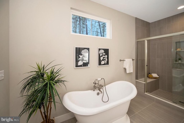 92 Mill Run, Bumpass, VA 23024 - bathroom featuring a soaking tub, baseboards, and a shower stall