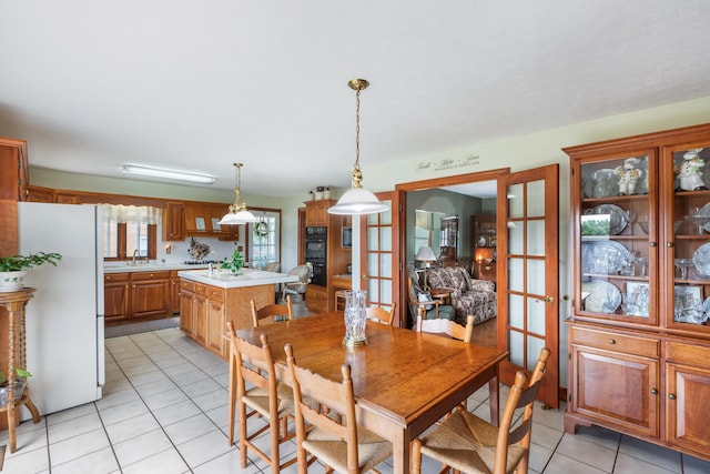 dining room with light tile patterned floors and french doors