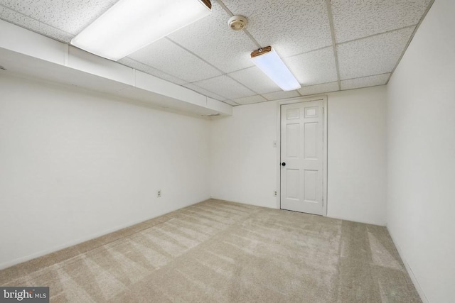  - finished below grade area featuring a paneled ceiling and carpet