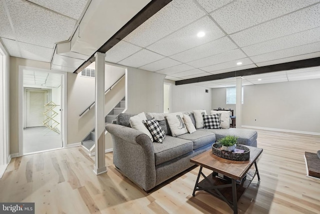  - living room featuring light wood finished floors, stairs, baseboards, a drop ceiling, and recessed lighting