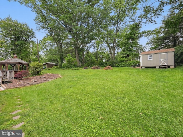  - view of grassy yard featuring a gazebo and a storage unit