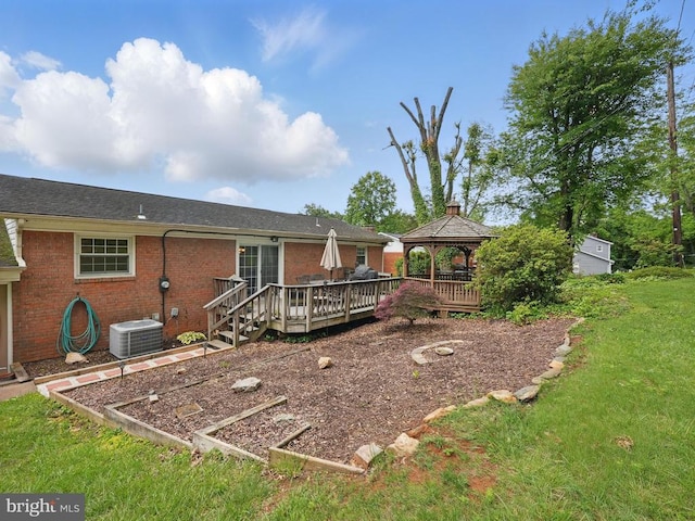  - rear view of house featuring a gazebo, cooling unit, a yard, a wooden deck, and brick siding