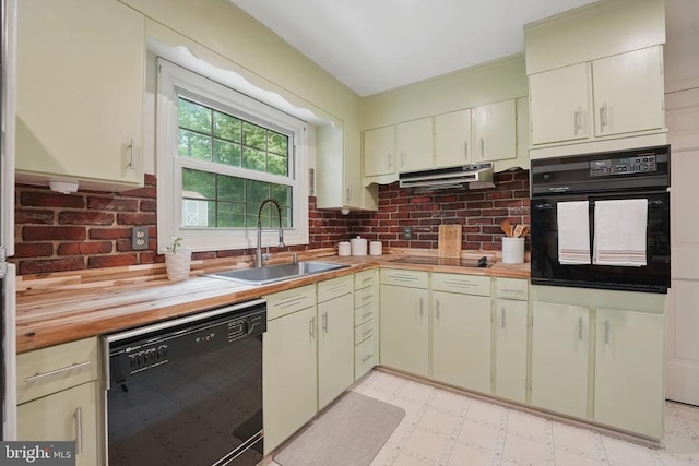  - kitchen featuring black appliances, a sink, under cabinet range hood, tasteful backsplash, and light flooring