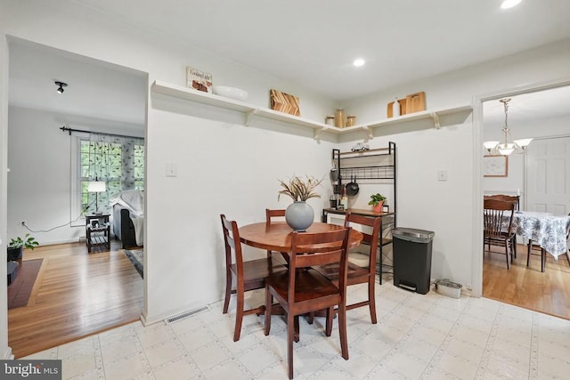  - dining area featuring light floors, recessed lighting, and a chandelier