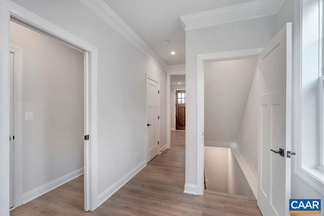 hall with baseboards, ornamental molding, recessed lighting, and wood finished floors