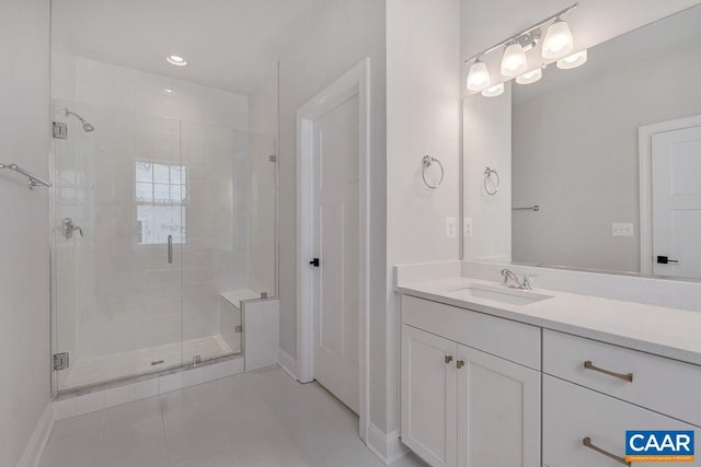 bathroom featuring a shower stall, baseboards, tile patterned floors, and vanity
