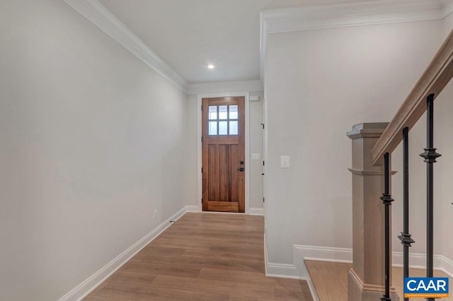 entrance foyer with recessed lighting, baseboards, ornamental molding, stairs, and wood finished floors