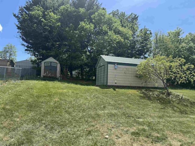 view of yard featuring a storage shed and an outdoor structure