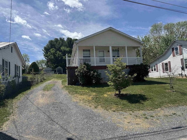 view of front of property featuring a porch and gravel driveway