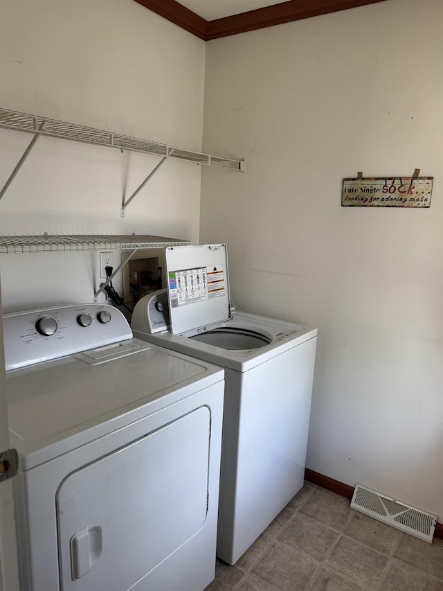 laundry area featuring independent washer and dryer and baseboards