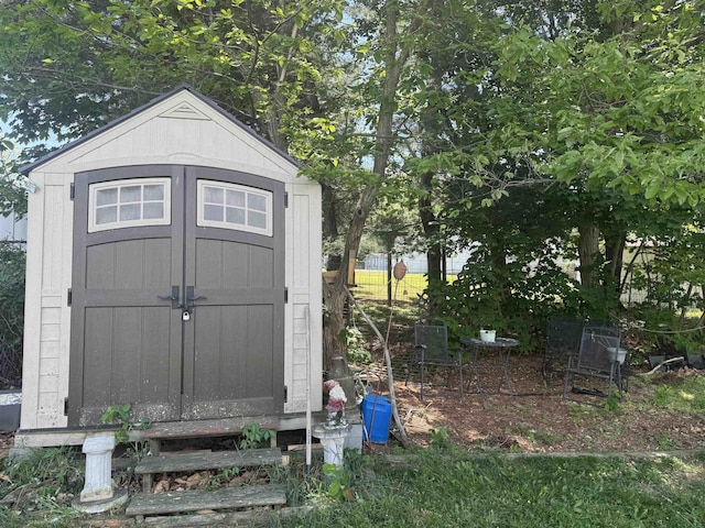 view of shed with fence