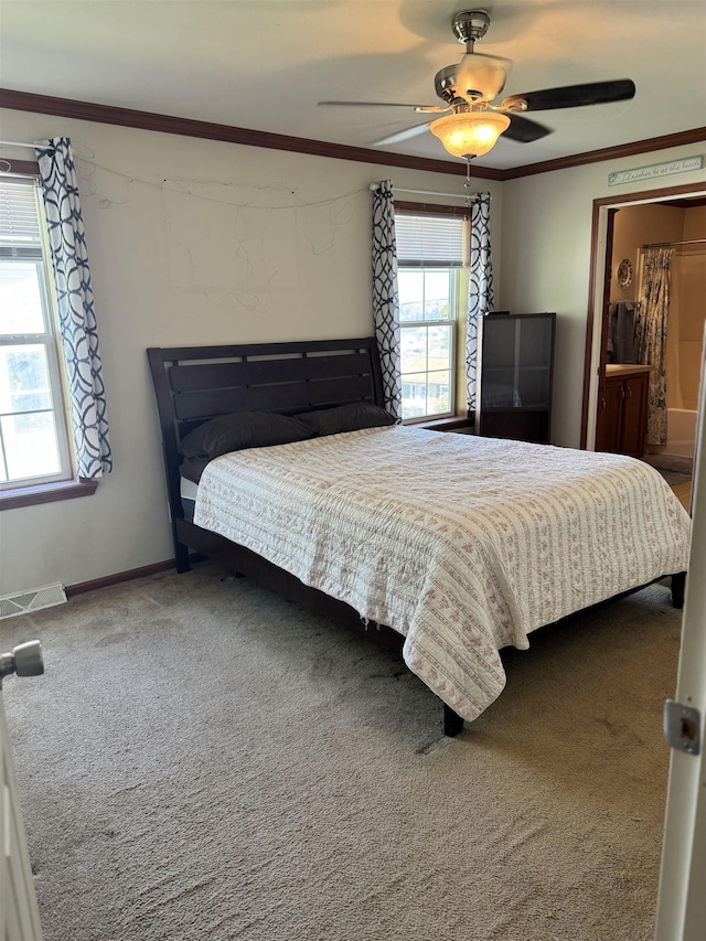 carpeted bedroom with crown molding, a ceiling fan, and baseboards