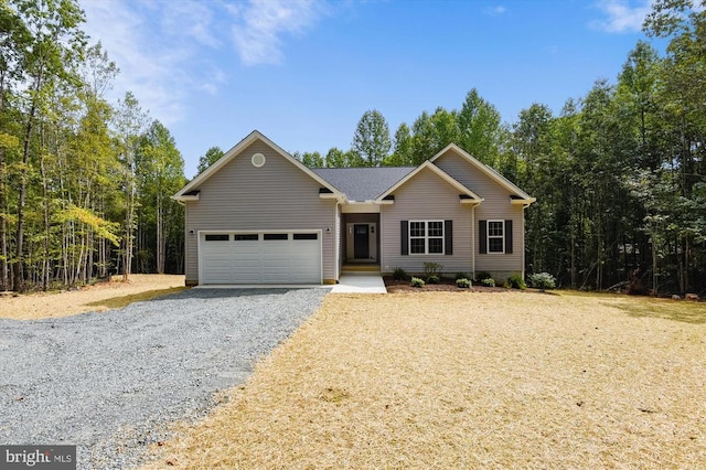 ranch-style house with an attached garage and gravel driveway