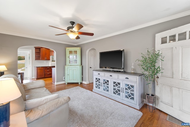 5998 Faber Rd, Faber, VA 22938 - living area featuring crown molding, wood finished floors, a ceiling fan, and arched walkways