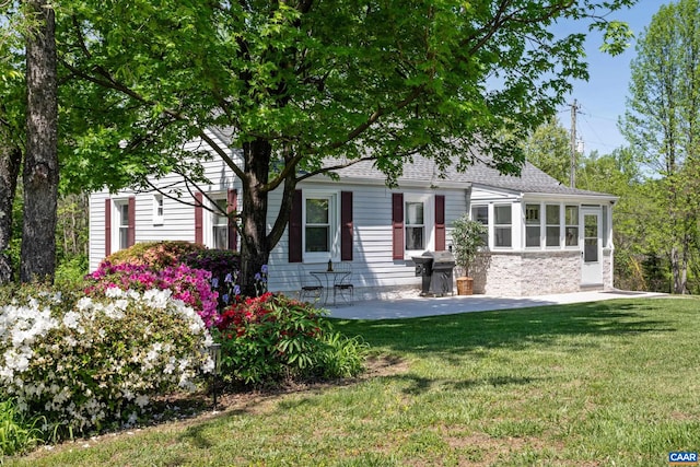 5998 Faber Rd, Faber, VA 22938 - view of front of home with a front lawn, roof with shingles, stone siding, a sunroom, and a patio area