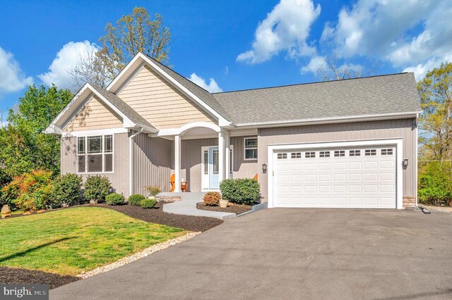 106 Wakefield Dr, Locust Grove, VA 22508 - view of front of home featuring driveway, an attached garage, a front yard, and roof with shingles