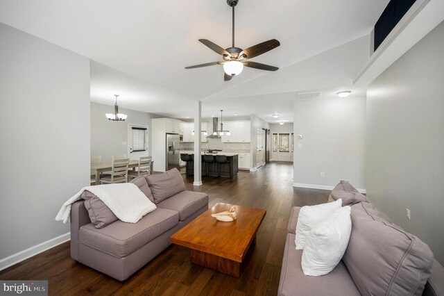 106 Wakefield Dr, Locust Grove, VA 22508 - living room with ceiling fan, a chandelier, lofted ceiling, dark wood-type flooring, and baseboards
