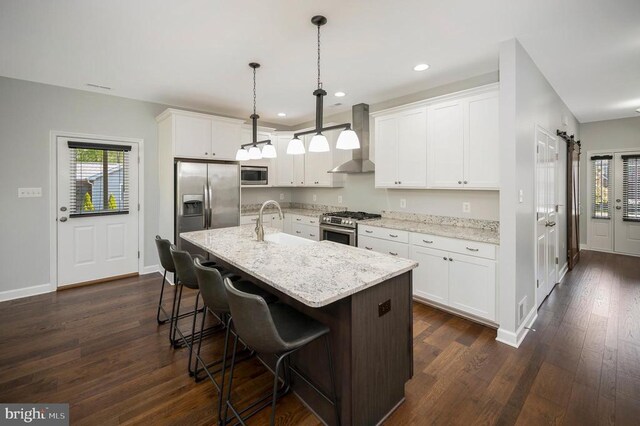 106 Wakefield Dr, Locust Grove, VA 22508 - kitchen featuring wall chimney range hood, appliances with stainless steel finishes, dark wood finished floors, white cabinetry, and recessed lighting