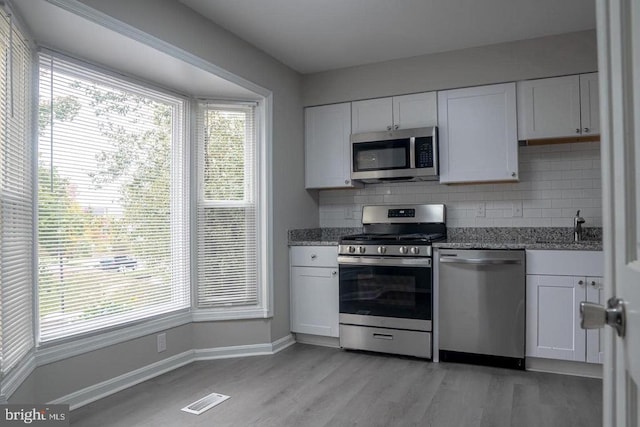 10732 Wakeman Dr, Fredericksburg, VA 22407 - kitchen with stainless steel appliances, tasteful backsplash, and plenty of natural light