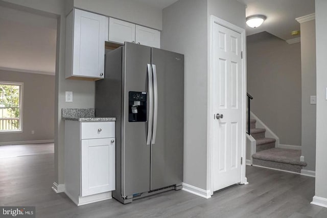 10732 Wakeman Dr, Fredericksburg, VA 22407 - kitchen featuring stainless steel refrigerator with ice dispenser, light wood-style flooring, white cabinetry, light stone countertops, and crown molding