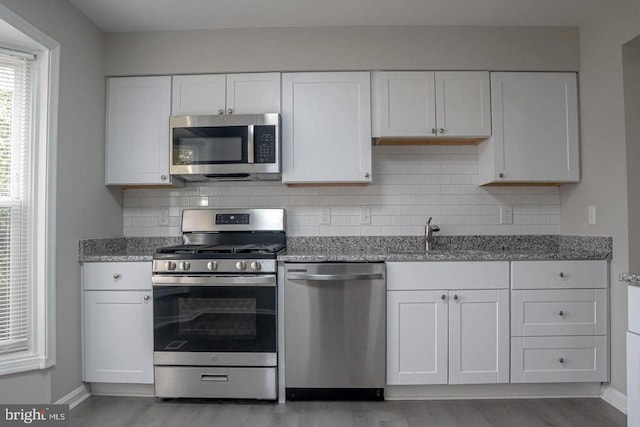10732 Wakeman Dr, Fredericksburg, VA 22407 - kitchen featuring appliances with stainless steel finishes, white cabinetry, and light stone counters