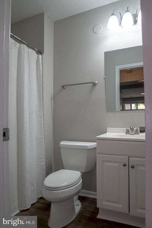10732 Wakeman Dr, Fredericksburg, VA 22407 - full bath featuring wood finished floors, vanity, and curtained shower