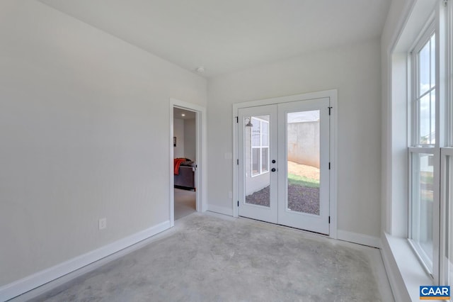 240 Thicket Run Dr, Charlottesville, VA 22911 - empty room featuring unfinished concrete floors, baseboards, and french doors