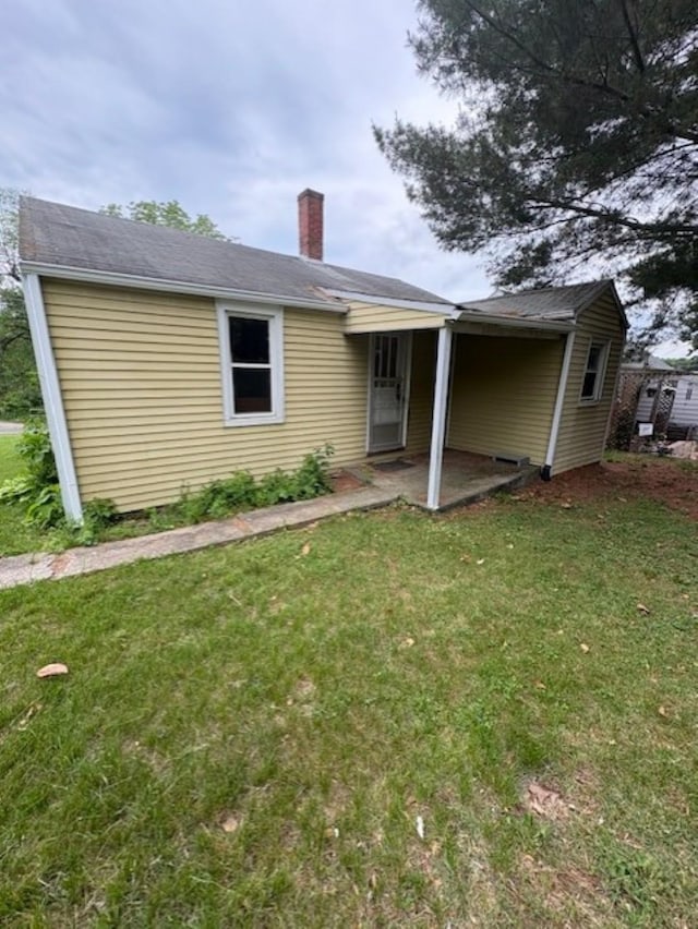 106 Grubert Ave, Staunton, VA 24401 - back of house with a chimney, a yard, and a patio area