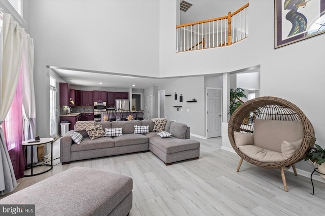 7922 Madison Plantation Way, Fredericksburg, VA 22407 - living room featuring a towering ceiling and light wood-style floors