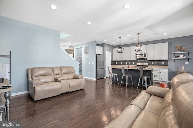 1906 Captain Dr, Fredericksburg, VA 22408 - living room with baseboards, recessed lighting, dark wood finished floors, and stairway