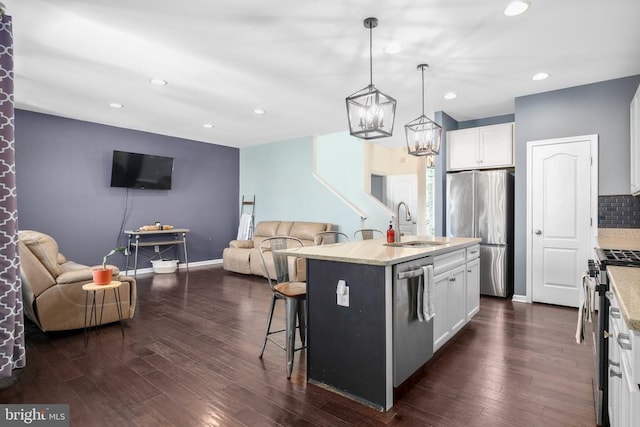 1906 Captain Dr, Fredericksburg, VA 22408 - kitchen featuring appliances with stainless steel finishes, open floor plan, a sink, a breakfast bar area, and recessed lighting