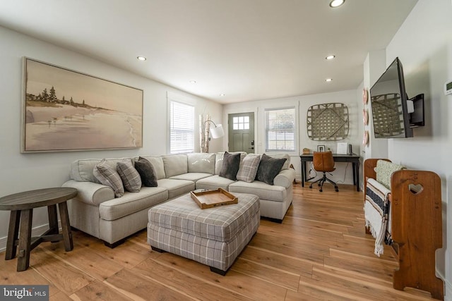 living room featuring light wood finished floors and recessed lighting