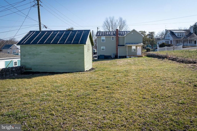 view of grassy yard featuring an outbuilding