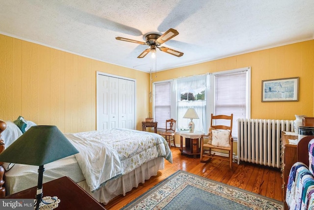 403 Long Ave, Shenandoah, VA 22849 - bedroom with radiator, wood finished floors, a closet, a textured ceiling, and ceiling fan