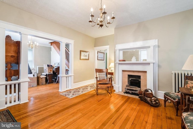 403 Long Ave, Shenandoah, VA 22849 - sitting room with a chandelier, radiator heating unit, light wood-style floors, a tile fireplace, and baseboards