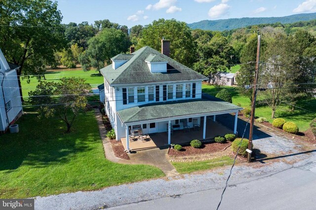 403 Long Ave, Shenandoah, VA 22849 - view of front of property with a chimney, a front yard, covered porch, a forest view, and a shingled roof