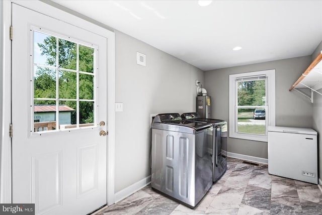 3048 Oakland Rd, Louisa, VA 23093 - washroom with washing machine and clothes dryer, electric water heater, baseboards, light marble finish floors, and recessed lighting