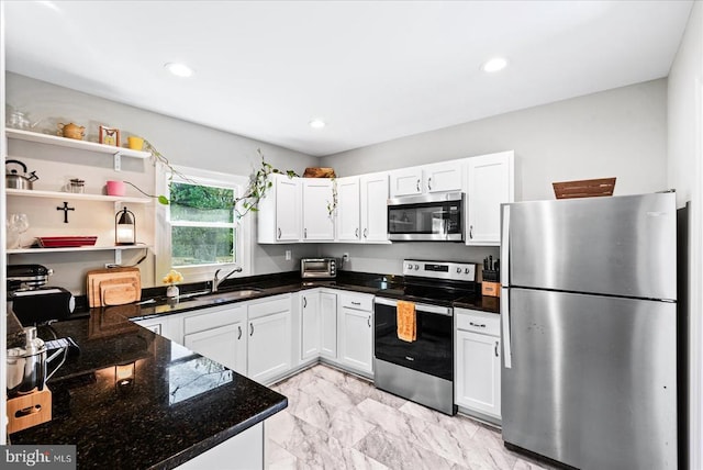 3048 Oakland Rd, Louisa, VA 23093 - kitchen featuring appliances with stainless steel finishes, light marble finish floors, white cabinetry, dark stone countertops, and recessed lighting