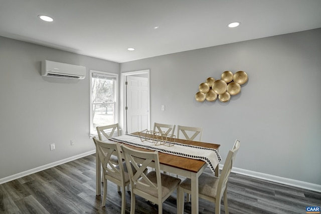 dining room featuring an AC wall unit, dark wood finished floors, baseboards, and recessed lighting