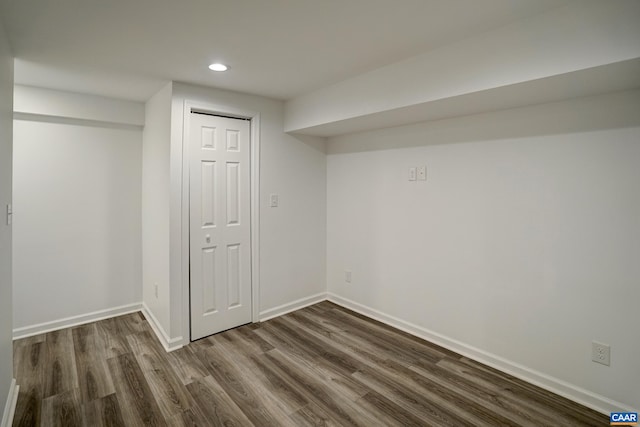 finished below grade area featuring dark wood-style floors, recessed lighting, and baseboards