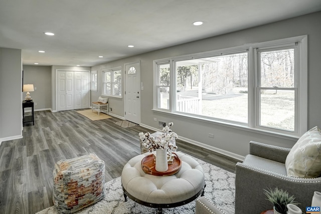 living room featuring baseboards, recessed lighting, and wood finished floors
