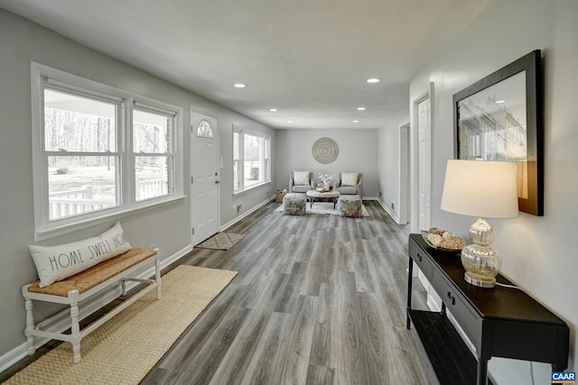 entryway with baseboards, wood finished floors, and recessed lighting
