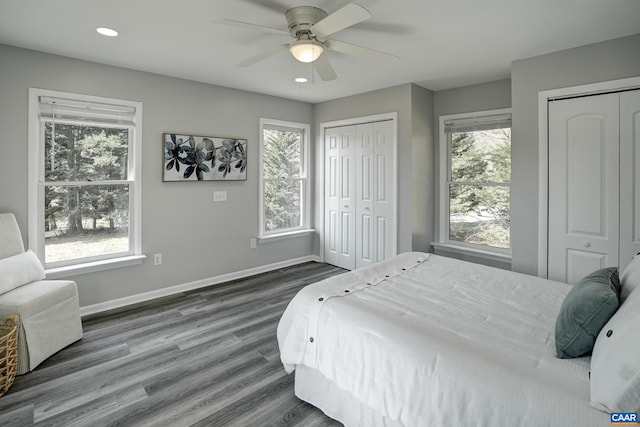 bedroom featuring two closets, multiple windows, baseboards, and recessed lighting