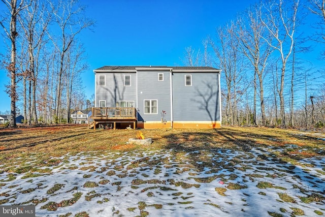 back of house with a deck